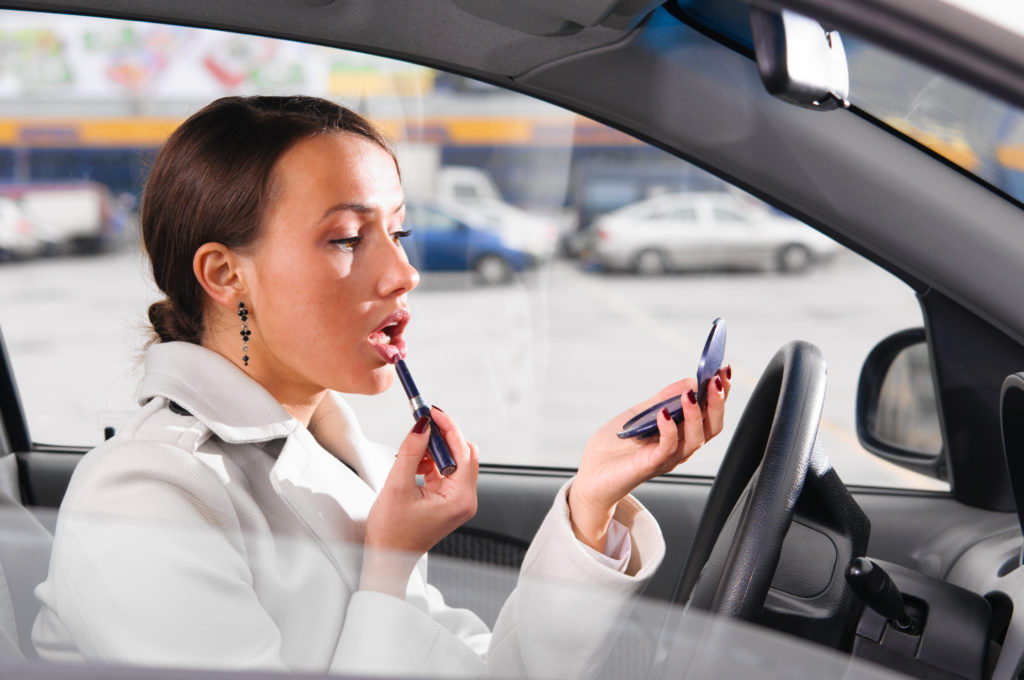 Lady applying makeup in car -- how to keep makeup in the car