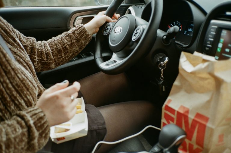 girl eating in the car