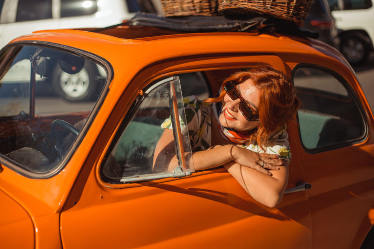 Lady sitting in orange car