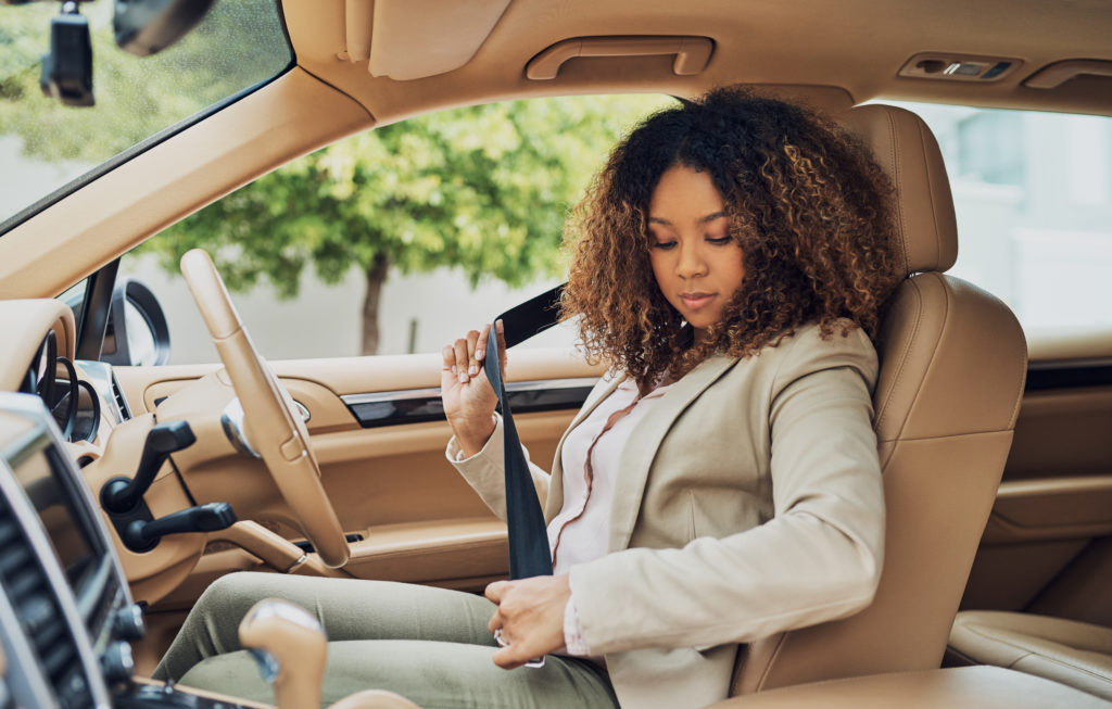 woman getting ready to drive to work with her vehicle - buying a car for work