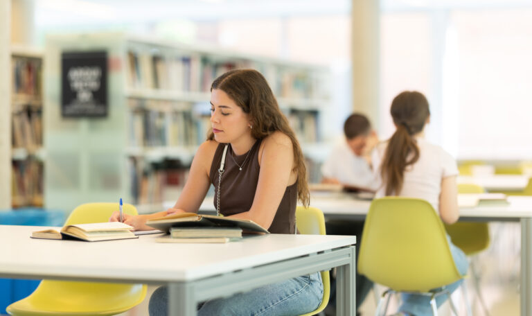 Girl sits and writes driving notes