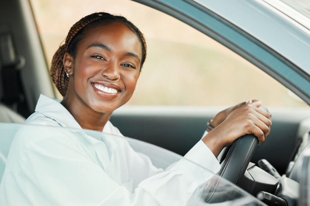 woman smiling because she passed her driving test the first time